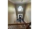Elevated view of the front entrance, showcasing the foyer's staircase, chandelier, and slate tile floor at 1931 Harvest Way, Loganville, GA 30052