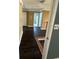 Hallway with dark wood floors, white doors, and access to other rooms at 1931 Harvest Way, Loganville, GA 30052