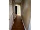 Neutral hallway with hardwood floors and access to multiple rooms at 1931 Harvest Way, Loganville, GA 30052