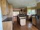 Bright kitchen with wood cabinets, an island, stainless steel appliances, and an adjacent dining area at 1931 Harvest Way, Loganville, GA 30052