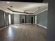 Spacious living room with hardwood floors and tray ceiling with fan at 1931 Harvest Way, Loganville, GA 30052