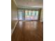Spacious living room with hardwood floors and french doors to the outdoor deck at 1931 Harvest Way, Loganville, GA 30052