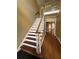 Traditional staircase with wood railings and trim, and a glimpse into adjacent living spaces at 1931 Harvest Way, Loganville, GA 30052