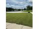 Wide street view showcasing lush green lawn, offering a serene and inviting neighborhood atmosphere at 1931 Harvest Way, Loganville, GA 30052