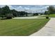 Street view featuring manicured lawns with inviting neighborhood ambiance and mature trees at 1931 Harvest Way, Loganville, GA 30052