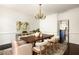 Spacious dining room featuring a wooden table, seating for six, elegant chandelier, and bright windows at 2600 Peachtree Nw Rd # 10, Atlanta, GA 30305