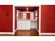 Wet bar between rooms featuring white cabinets, countertop, and a sink with shelving above at 2600 Peachtree Nw Rd # 10, Atlanta, GA 30305