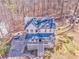 Expansive aerial perspective of a two-story home surrounded by a lush forest at 2738 Allyn Nw Way, Kennesaw, GA 30152