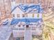 Aerial view of a white two-story home showcasing its roof, porch, and surrounding landscape at 2738 Allyn Nw Way, Kennesaw, GA 30152