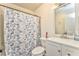 Bright bathroom featuring a vanity, mirror, and a shower with a butterfly-patterned curtain at 2738 Allyn Nw Way, Kennesaw, GA 30152