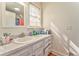 Bathroom with white vanity, vintage style faucet, and wood-look flooring at 2738 Allyn Nw Way, Kennesaw, GA 30152