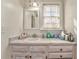 Bathroom featuring a white vanity with ample storage space and a bright window at 2738 Allyn Nw Way, Kennesaw, GA 30152