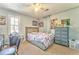 Comfortable bedroom with ceiling fan, desk, and cozy carpet for a relaxing space at 2738 Allyn Nw Way, Kennesaw, GA 30152