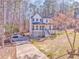 A side-angle view of a two-story home with a driveway and expansive front yard at 2738 Allyn Nw Way, Kennesaw, GA 30152