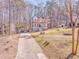 Two-story home situated on a spacious lot with a private driveway and surrounding trees at 2738 Allyn Nw Way, Kennesaw, GA 30152