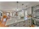 Open concept kitchen with island and adjacent living area with fireplace at 2738 Allyn Nw Way, Kennesaw, GA 30152