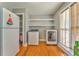 Bright laundry room with washer, dryer, storage shelves, and natural light at 2738 Allyn Nw Way, Kennesaw, GA 30152