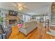 Open-concept living room with a stone fireplace, hardwood floors, and seamless access to the kitchen at 2738 Allyn Nw Way, Kennesaw, GA 30152