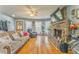 Cozy living room with a stone fireplace, hardwood floors, and comfortable seating at 2738 Allyn Nw Way, Kennesaw, GA 30152