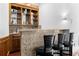 Wet bar featuring granite countertops, dark wood, and barstool seating at 3670 River Mansion Dr, Peachtree Corners, GA 30096
