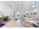 Luxurious bathroom with a standalone tub, marble floors, and ample natural light at 3670 River Mansion Dr, Peachtree Corners, GA 30096