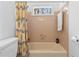 Bathroom featuring a tub with yellow curtain and a window at 3670 River Mansion Dr, Peachtree Corners, GA 30096