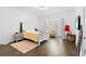 Bedroom with a bay window, wood floors, a white bed frame, and a plush rug at 3670 River Mansion Dr, Peachtree Corners, GA 30096