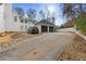 Driveway featuring a two car garage and view of the back of the house at 3670 River Mansion Dr, Peachtree Corners, GA 30096