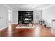 Well-lit home office with hardwood floors, built-in shelving, and a large window at 3670 River Mansion Dr, Peachtree Corners, GA 30096