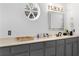 Grey vanity with a large countertop, a round window, and bright lighting at 3670 River Mansion Dr, Peachtree Corners, GA 30096