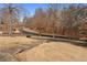 Yard featuring a driveway and grassy area with mature trees at 3670 River Mansion Dr, Peachtree Corners, GA 30096
