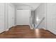 Upstairs hallway with hardwood floors, neutral paint, and doors leading to the bedrooms at 236 Rankin Cir, Mcdonough, GA 30253