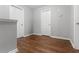 Bright hallway with hardwood floors and access to various rooms in the home at 236 Rankin Cir, Mcdonough, GA 30253