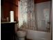 Bathroom with a toilet, white shower, and patterned shower curtain at 3429 Lake End Dr, Loganville, GA 30052
