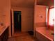 Bathroom with double vanity, bathtub, tiled floors, and natural lighting at 3429 Lake End Dr, Loganville, GA 30052