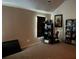 Bedroom featuring vaulted ceiling, a window, carpeting, and an entertainment center at 3429 Lake End Dr, Loganville, GA 30052