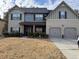 Charming two-story home featuring a two-car garage, well-maintained lawn, and classic architectural details at 3429 Lake End Dr, Loganville, GA 30052