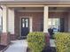 Inviting front porch with brick accents, decorative wreath on the front door, and space for seating at 3429 Lake End Dr, Loganville, GA 30052