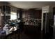 Spacious kitchen with dark cabinets, an island, a pantry, and stainless steel appliances at 3429 Lake End Dr, Loganville, GA 30052