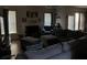 Relaxing living room with gray sectional, fireplace, and large windows with blinds at 3429 Lake End Dr, Loganville, GA 30052
