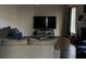 Comfortable living room with a gray couch, large TV, hardwood floors, and fireplace at 3429 Lake End Dr, Loganville, GA 30052