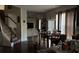 Inviting living room features an open staircase, a large TV, and a view of the dining area at 3429 Lake End Dr, Loganville, GA 30052