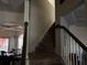 View of carpeted staircase and dining area with coffered ceiling in this lovely home at 3429 Lake End Dr, Loganville, GA 30052