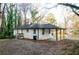 A view of the home's exterior featuring the covered parking, tidy lawn and easy driveway access at 2895 Akron St, Atlanta, GA 30344