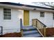 Inviting home exterior featuring a quaint entrance with steps and a bright, mustard-colored door at 2895 Akron St, Atlanta, GA 30344