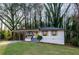 Charming single-story home featuring a covered porch and freshly painted exterior with decorative window shutters at 2895 Akron St, Atlanta, GA 30344