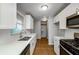 Contemporary kitchen with stainless steel appliances, white cabinets, and bright lighting at 2895 Akron St, Atlanta, GA 30344