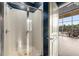 Bright bathroom with a glass-enclosed shower, white tiles, and access to a balcony offering natural light at 3400 Malone Dr # 303, Atlanta, GA 30341