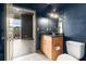 Bathroom featuring dark blue walls, tiled flooring, toilet and sink, and a view of the outdoor balcony at 3400 Malone Dr # 303, Atlanta, GA 30341