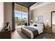 Bright bedroom boasts a large window with curtains and balcony access, complemented by stylish furniture and decor at 3400 Malone Dr # 303, Atlanta, GA 30341